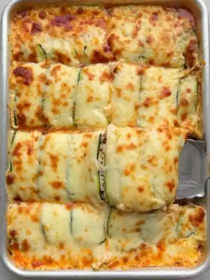 Zucchini lasagna in a sheet pan with golden, bubbling mozzarella on top