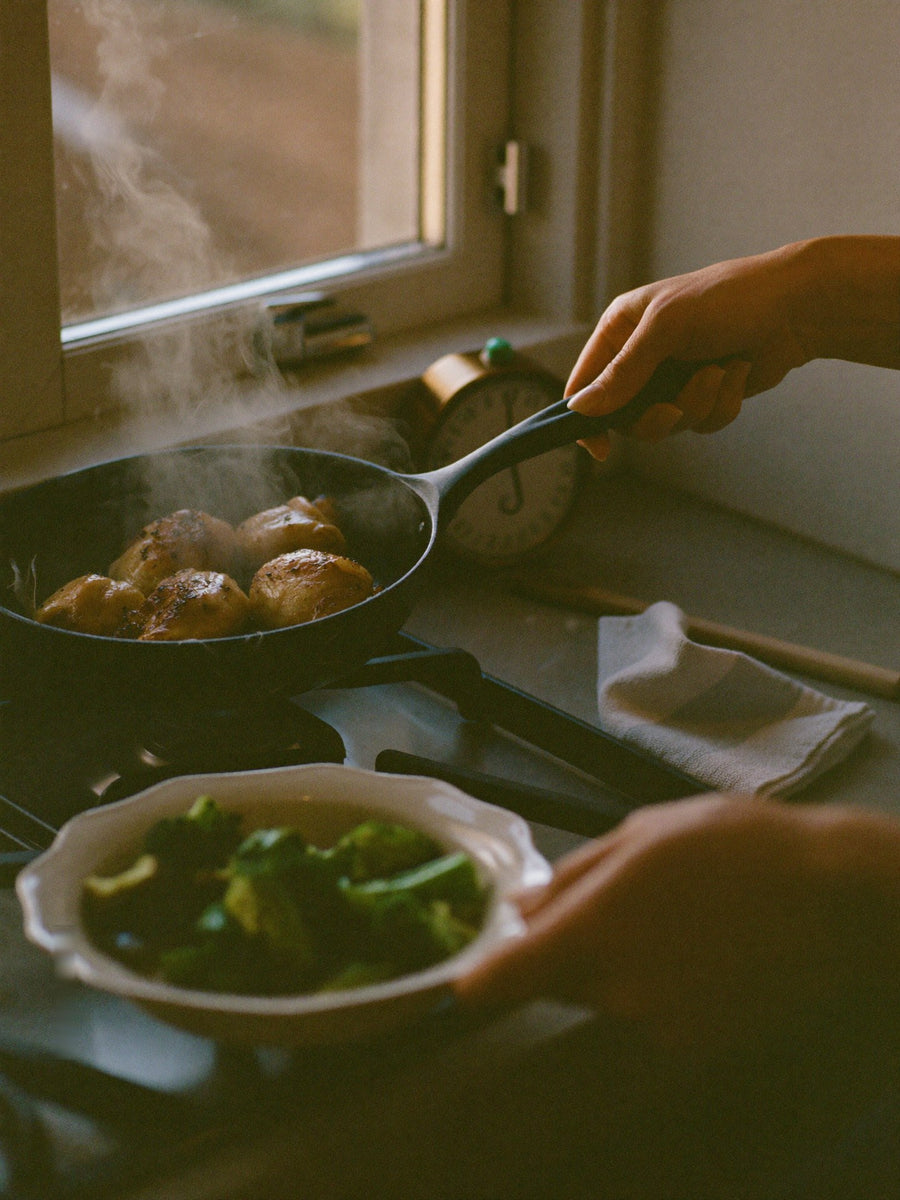 Chicken cooking in a cast-iron pan on a weeknight